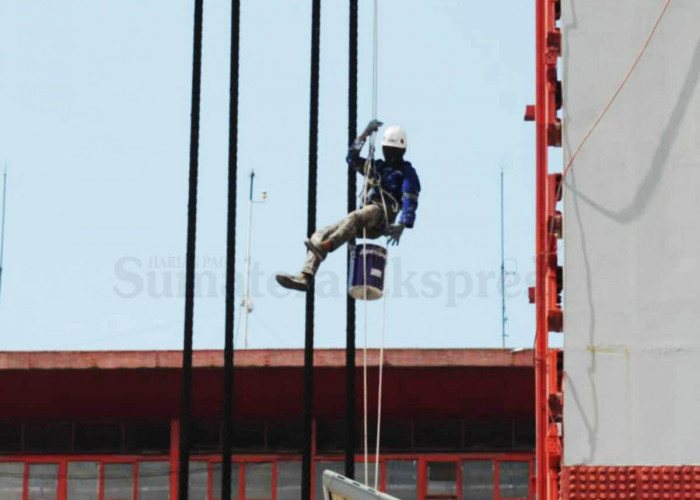 BEKERJA DI ATAS KETINGGIAN-Salah satu pekerja yang sudah memiliki sertifikat khusus sedang melakukan pekerjaan pengecatan salah satu menara Jembatan Ampera Palembang di atas ketinggian 63 Meter, Sabtu (22/07/2023). Pekerja ini sudah memenuhi standar keselamatan K3 seperti menggunakan APD lengkap, safety belt pinggang, full body harness di tubuh, mematuhi teknik bekerja aman serta sudah menjadi peserta BPJS ketenagakerjaan. Foto : Budiman/Sumateraekspres.id